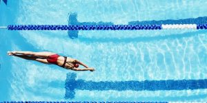 female competitive swimmer diving into pool royalty free image 1594380956