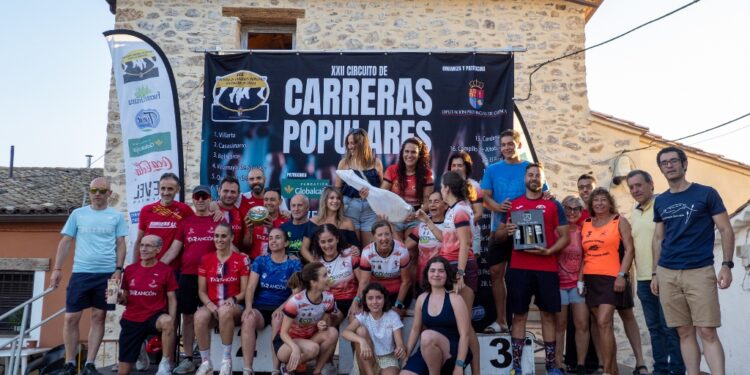 Paloma Serrano y Andrés Felipe Sarta dominan el calor en la XXI Carrera Popular de Uña 1 La localidad conquense de Uña celebró este pasado sábado 4 de julio la vigesimoprimera edición de su Carrera Popular, marcando el ecuador del XXII Circuito de Carreras Populares de la Diputación de Cuenca. Un total de 346 corredores lograron cruzar la línea de meta tras completar las dos vueltas al tradicional recorrido que bordea la laguna. Las altas temperaturas endurecieron esta decimocuarta prueba puntuable, lo que motivó al Ayuntamiento a instalar un punto extra de avituallamiento en la plaza principal al término de la primera vuelta. Esta medida, sumada a las zonas de sombra naturales del trazado, fue clave para garantizar la correcta hidratación de todos los participantes. En el plano estrictamente deportivo, Andrés Felipe Sarta Montoya, del C.A. Reajo Fontense, se alzó con la victoria absoluta masculina tras detener el cronómetro en 25:07, imponiendo un exigente ritmo de 3:26 minutos por kilómetro. Le acompañaron en el podio su compañero de equipo John Kurui Chebii (25:17) y Alfonso Expósito Giménez, del Club Atletismo Iniesta (25:58). Por su parte, la categoría femenina estuvo liderada por Paloma Serrano Esteban, del Rujamar Atletismo Cuenca, quien cruzó la meta en 30:47 y logró el trigésimo puesto en la clasificación general absoluta. La siguieron muy de cerca Alba Barambio Martínez (30:50) y Ana Belén Sánchez Castellanos (33:04). Los atletas locales también tuvieron un papel protagonista ante su público. Marcos Refusta Mancheño fue el corredor más rápido del municipio con un tiempo de 31:35, mientras que Laura Gómez Lasso hizo lo propio en la categoría femenina local, parando el reloj en 33:11 y alcanzando la tercera posición en la tabla Senior. Por equipos, el Rujamar Atletismo Cuenca dominó la jornada llevándose el primer puesto tanto en la clasificación general como en la femenina. La tarde concluyó con la entrega de trofeos a cargo del alcalde José Luis Gómez Bachiller y la tradicional degustación de paella en el merendero cercano a la laguna. Archivo y evolución del circuito provincial A lo largo de sus más de dos décadas de historia, el Circuito de Carreras Populares de la Diputación de Cuenca se ha consolidado como la principal columna vertebral del deporte amateur en la provincia. La prueba de Uña mantiene intacto su poder de convocatoria año tras año gracias al singular entorno de su laguna, un escenario que históricamente ha funcionado como refugio natural para los corredores durante el calendario estival. Revisando la trayectoria de estas competiciones, se observa una evolución constante en el nivel de los clubes provinciales, reflejada en la actual hegemonía de formaciones como el Rujamar Atletismo Cuenca y el C.A. Reajo Fontense. La incorporación de mejoras logísticas recientes demuestra cómo la organización se adapta a los nuevos retos climáticos. La decisión de añadir puntos de hidratación extraordinarios evidencia la preparación de los ayuntamientos conquenses ante las intensas olas de calor, priorizando en todo momento la seguridad de los deportistas sin renunciar a la exigencia de la prueba. El circuito provincial continuará su marcha el próximo 18 de julio en Cardenete con la carrera "Los Sanochaores", la cita deportiva más veterana de la provincia, que con su 51ª edición reafirmará el profundo arraigo del atletismo popular en los municipios de Cuenca.
